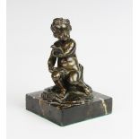 A Grand Tour bronze putto, 19th century, modelled partially covered with a cloth, seated upon a