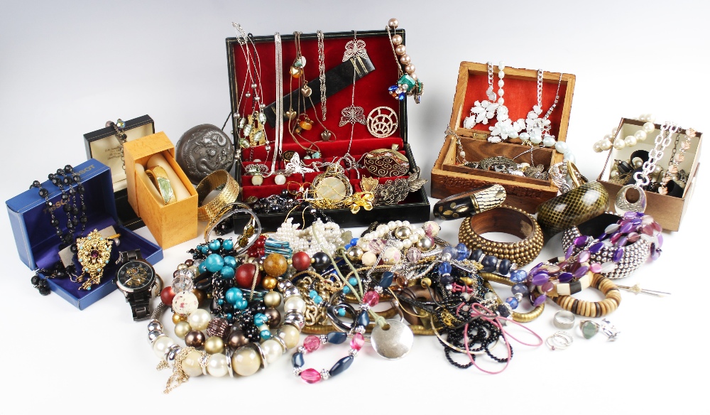 A large collection of vintage and modern costume jewellery, including beaded necklaces, chains,