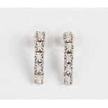 A pair of diamond drop earrings, comprising five round illusion cut diamonds, each illusion set to a