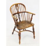 An early 19th century ash and fruit wood Windsor farmhouse elbow chair, the arched stick back with