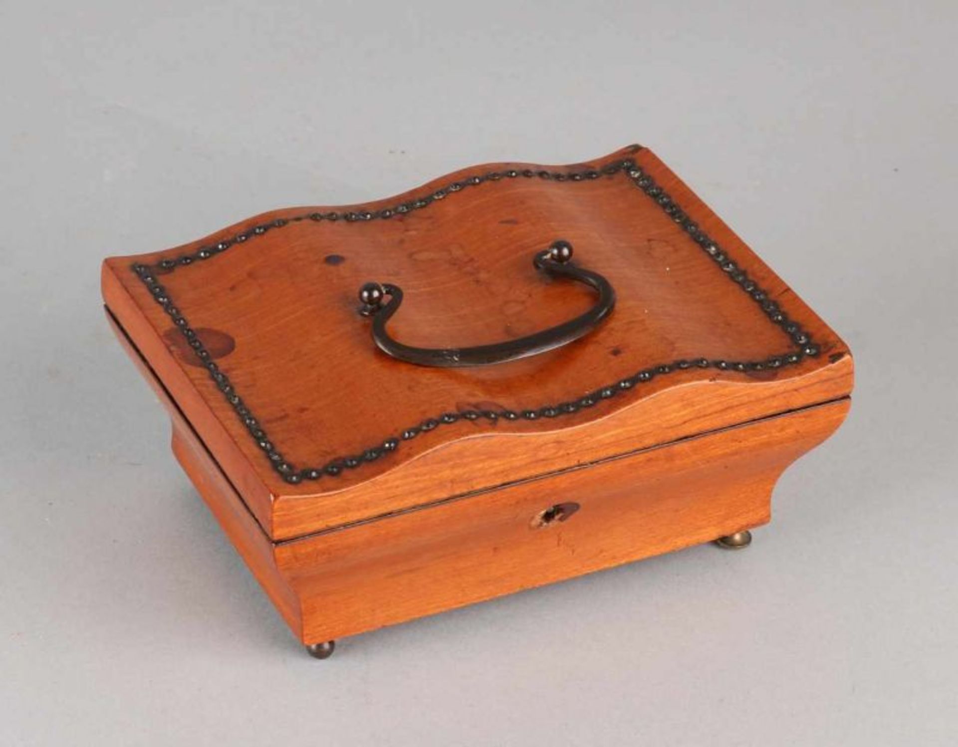 19th Century mahogany wooden box with a curved handle. One leg loose it. Not original. Size: 6.5 x