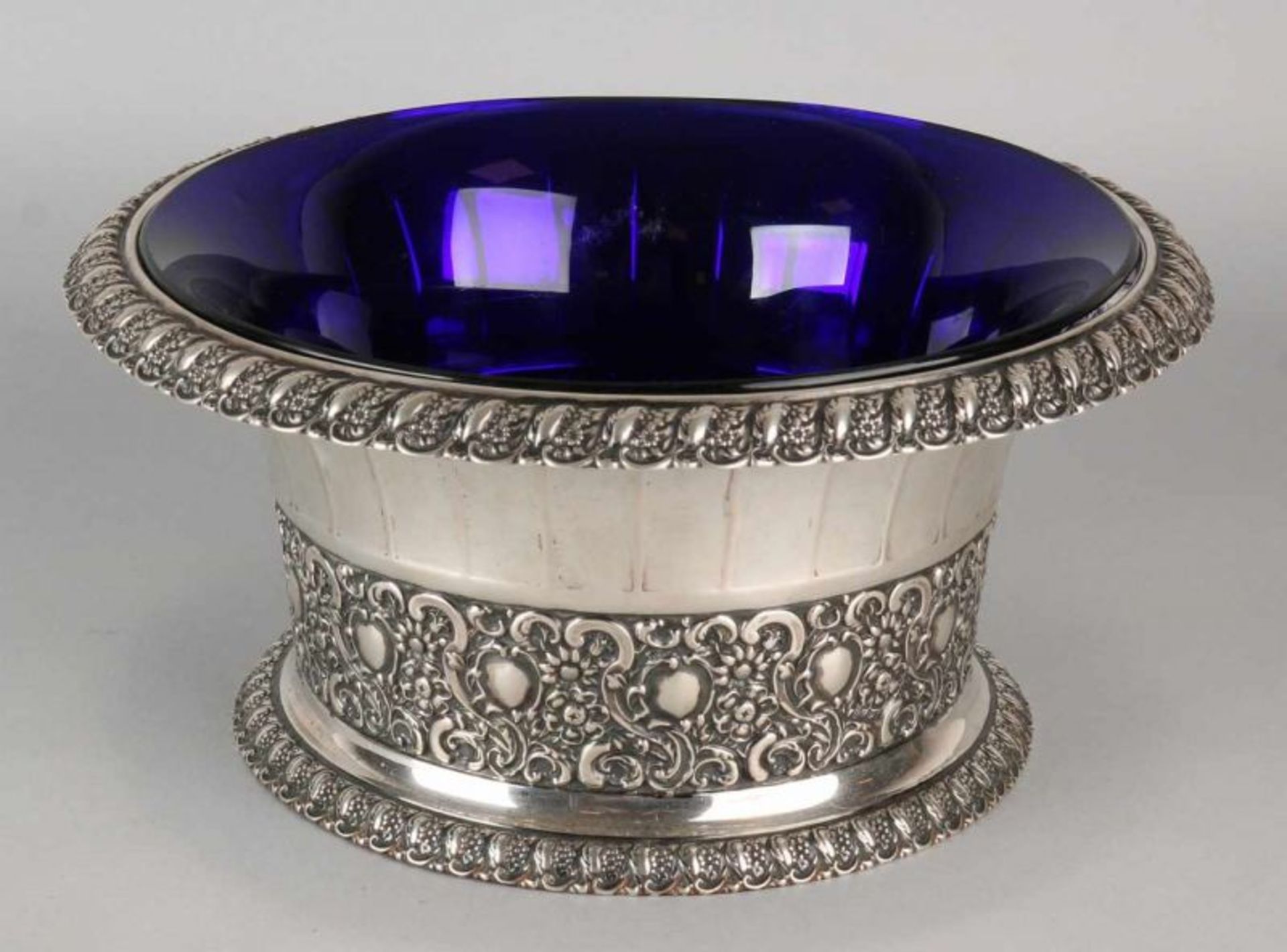 Large silver tray, 800/000, with blue glass liner. Round model decorated with ribs, a folded-back