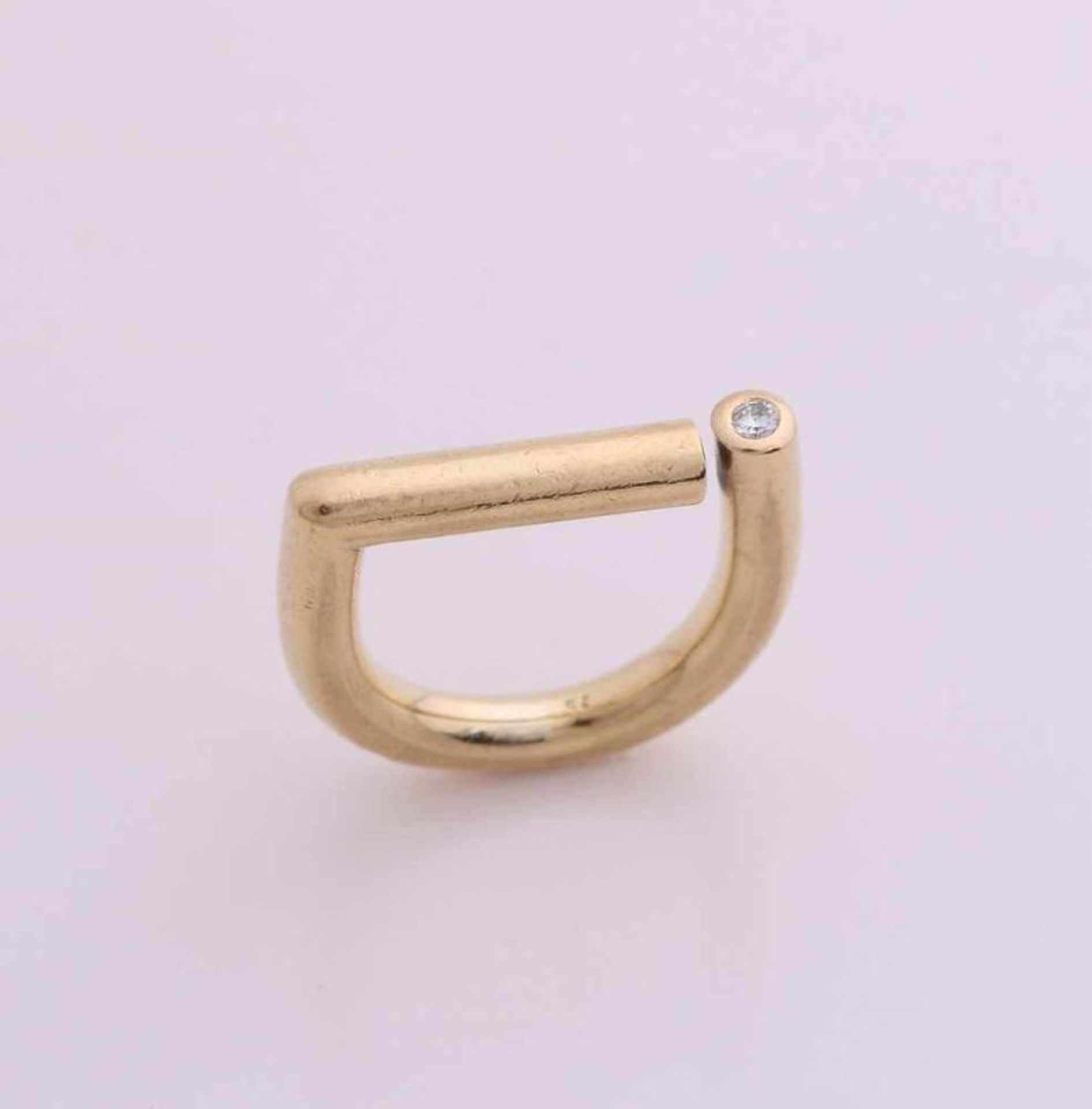 Tight yellow gold ring, 750/000, with diamond. Ring made of round wire, bent and engaged with a