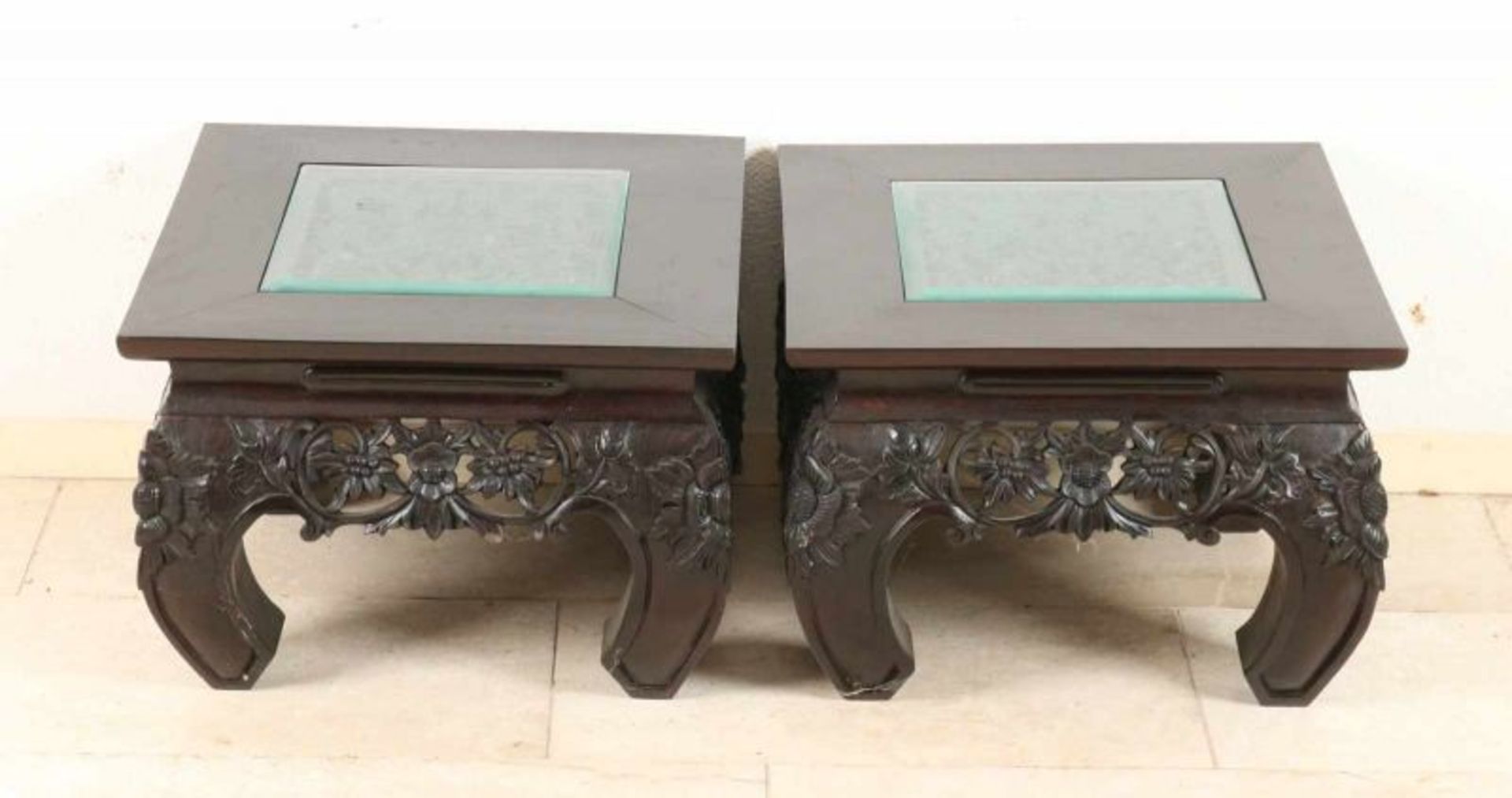 Two Oriental carved teak side tables. 20th century. Size: 35 x 50 x 50 cm. In good condition.
