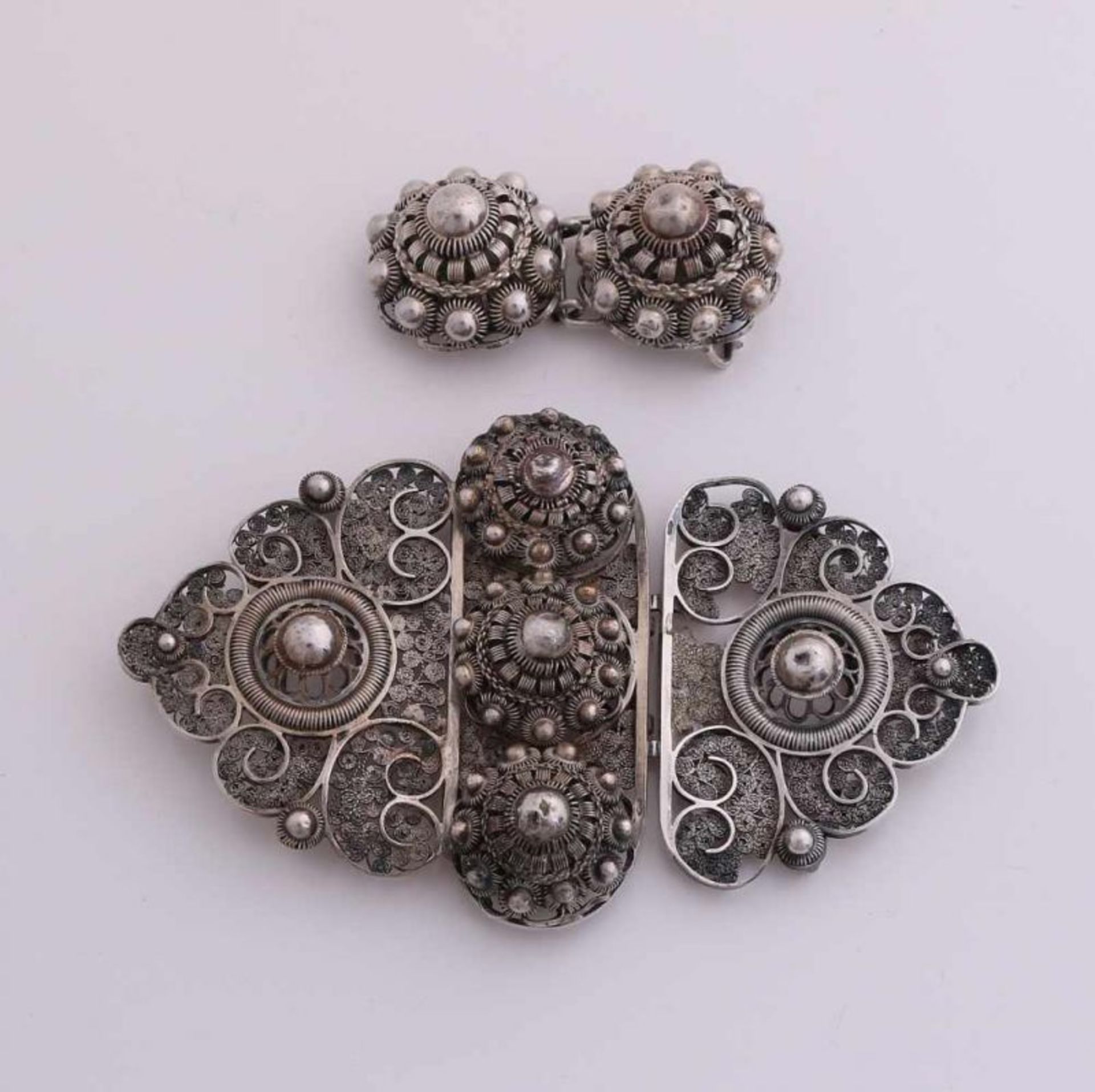 Two silver buckles, 835/000, with Zeeland buttons. Large oval molded buckle with filigree and