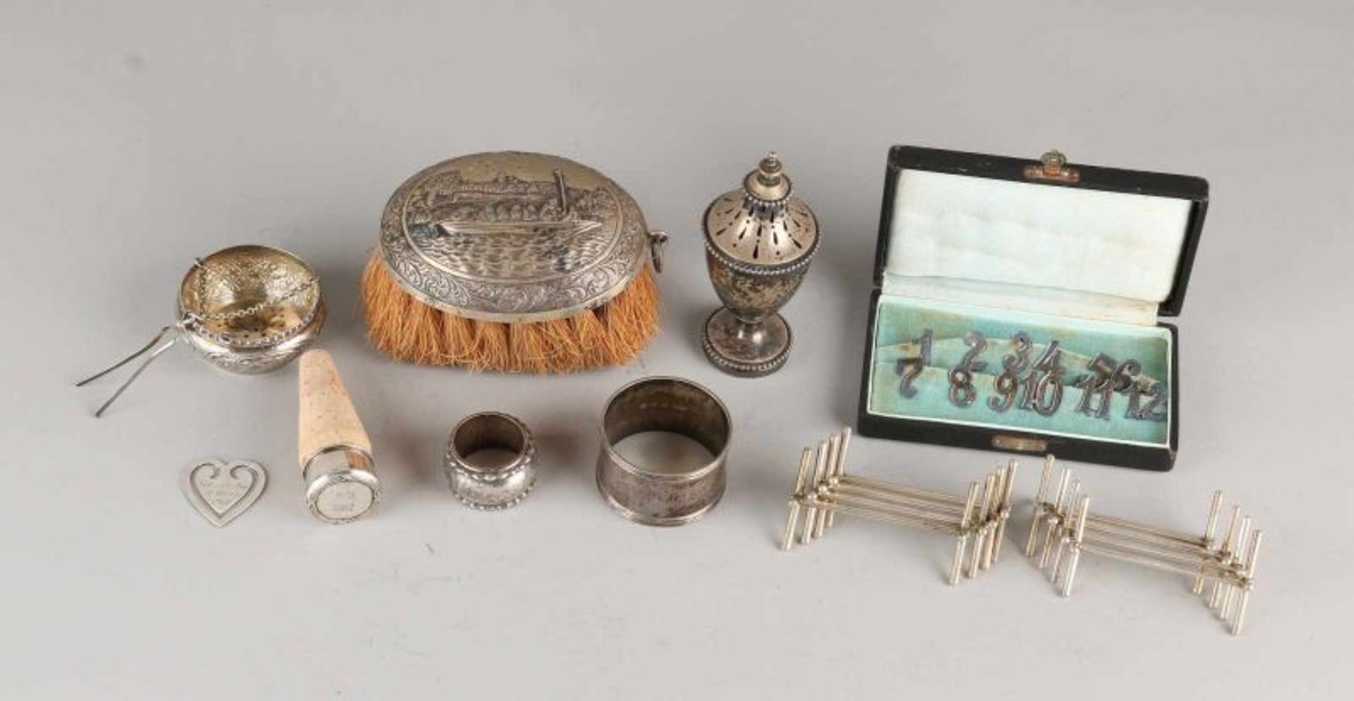 Lot silverware table with brush depicting a spreader on a roll, napkin ring and two small napkin