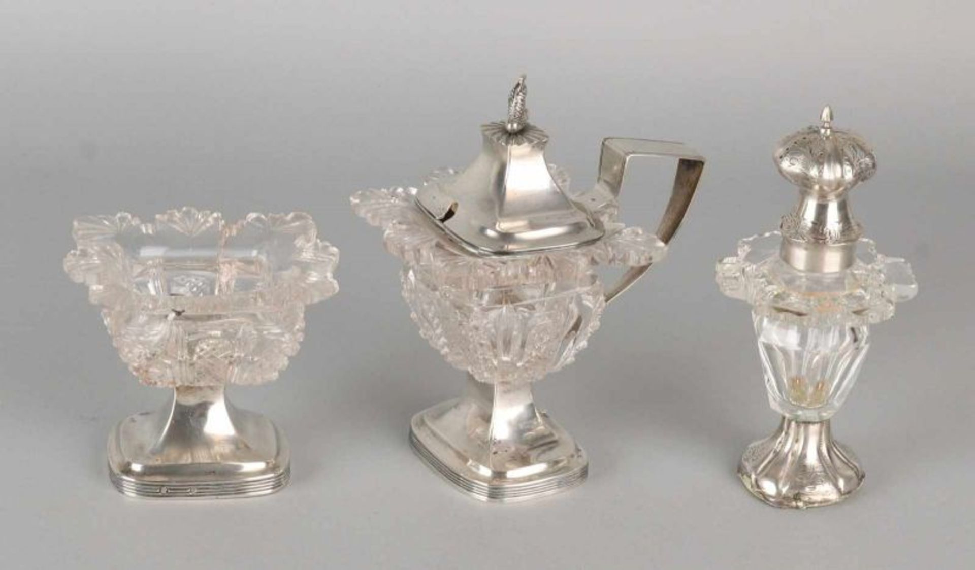 Crystal spreader, mustard bowl and spice tray with silver. A spreader with grinding work, on a round