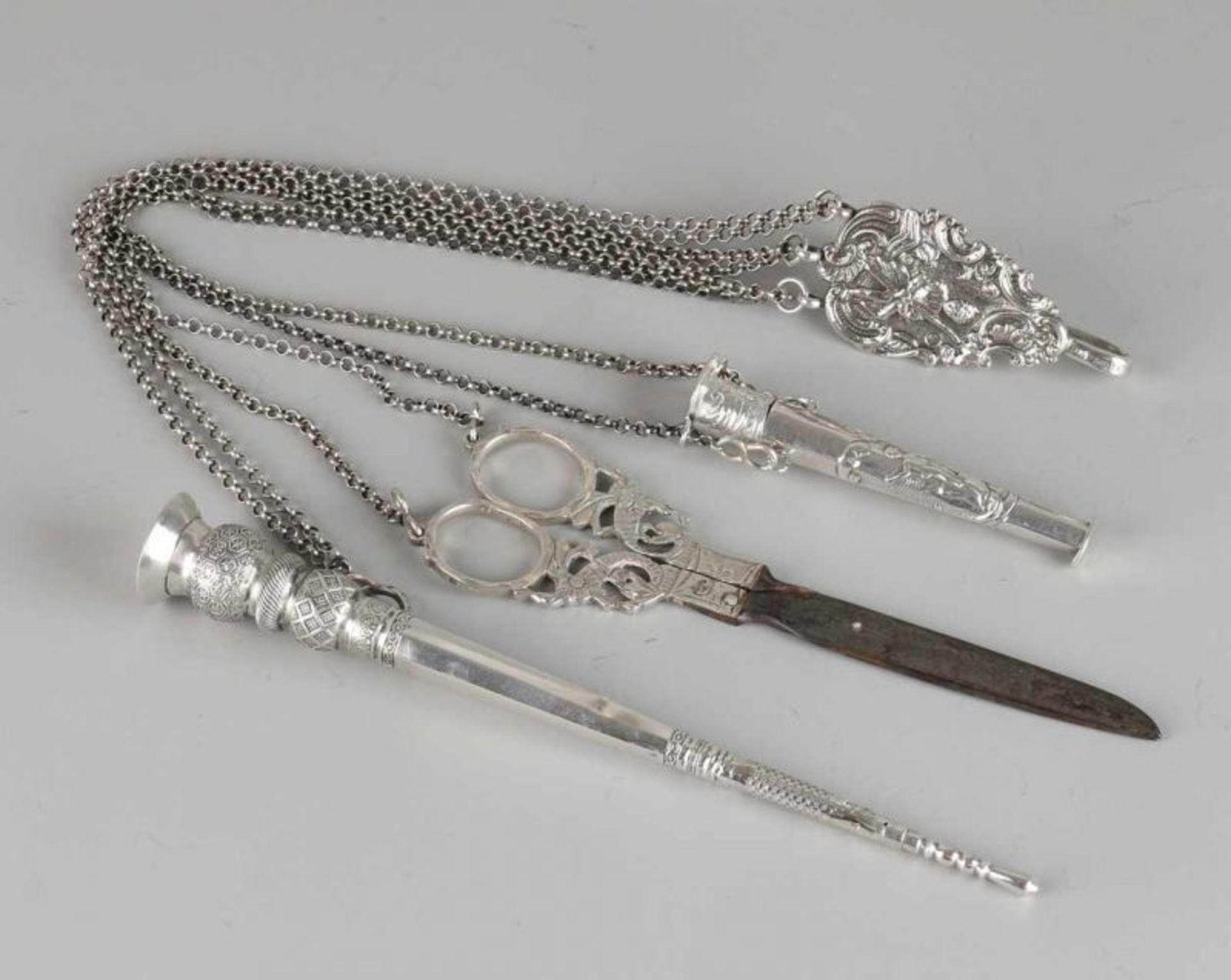 Silver chatelaine with rokhaak, scissors, needle case and breipenschede, 833/000. Pear-shaped