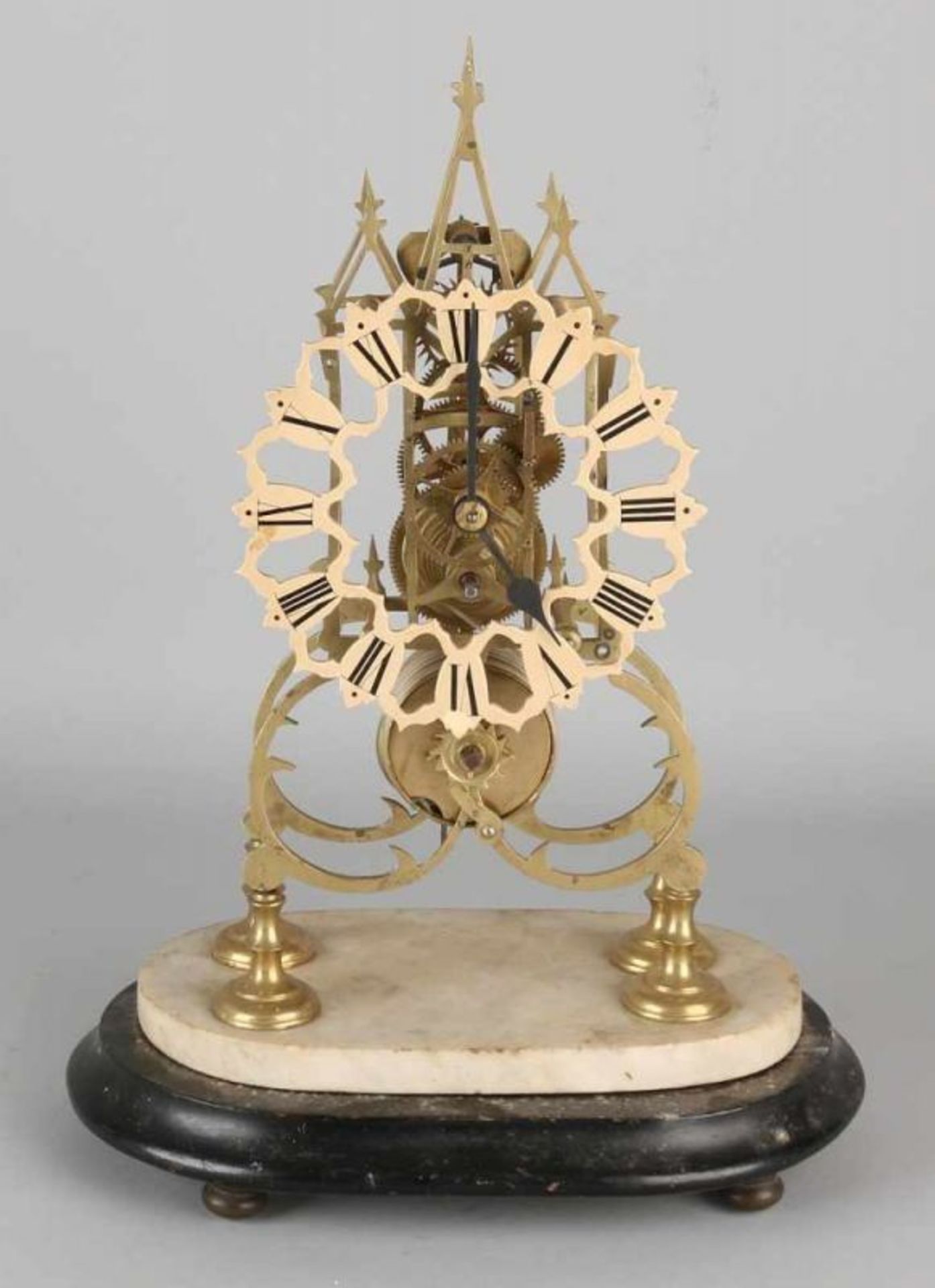 Antique English brass skeleton clock with fusee. On wood with alabaster basement. Circa 1880.