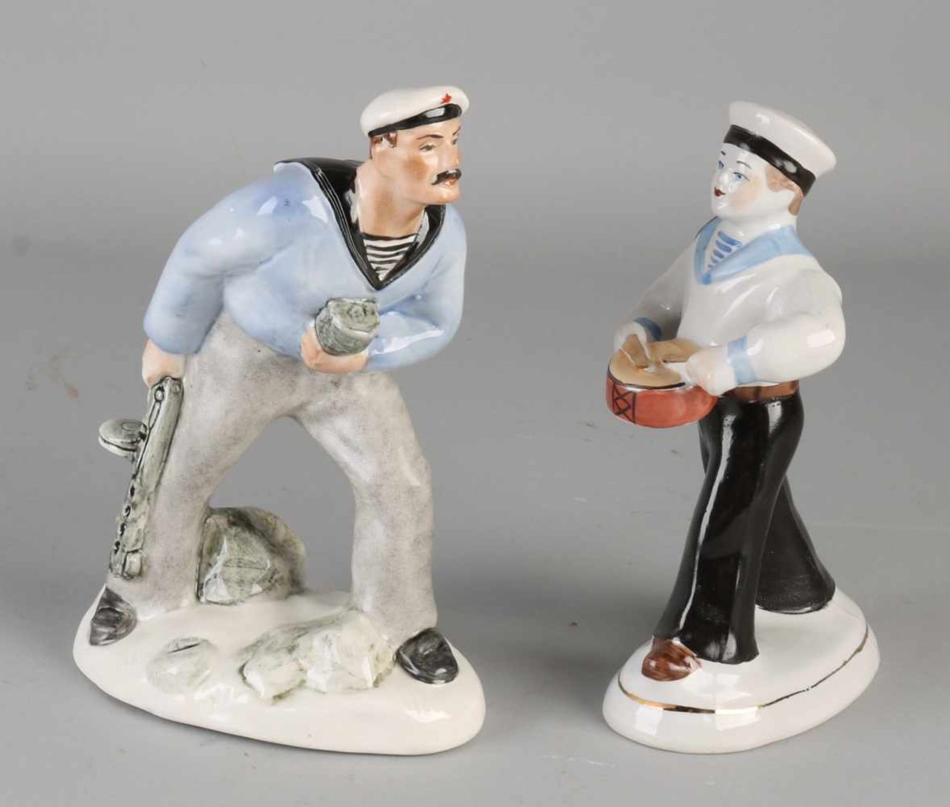 Two old Russian porcelain figures. One times sailor with drum. One sailor times with machine gun (