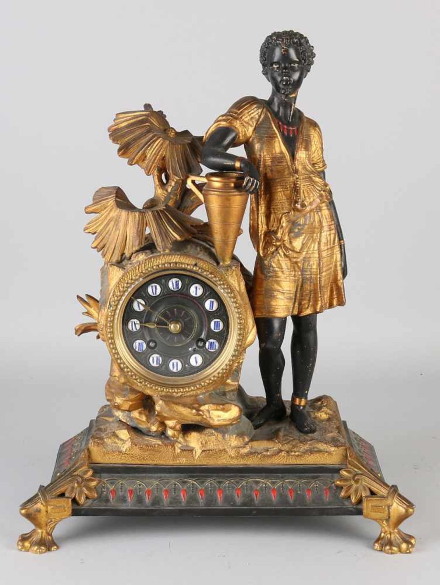 19th Century French pendulum clock with negroid figure, palm type and vase. Eight day-movement,