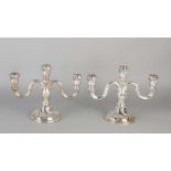 Two silver table candlesticks 835/000, 3 light on a round base with two twisted arms curled. MT .: