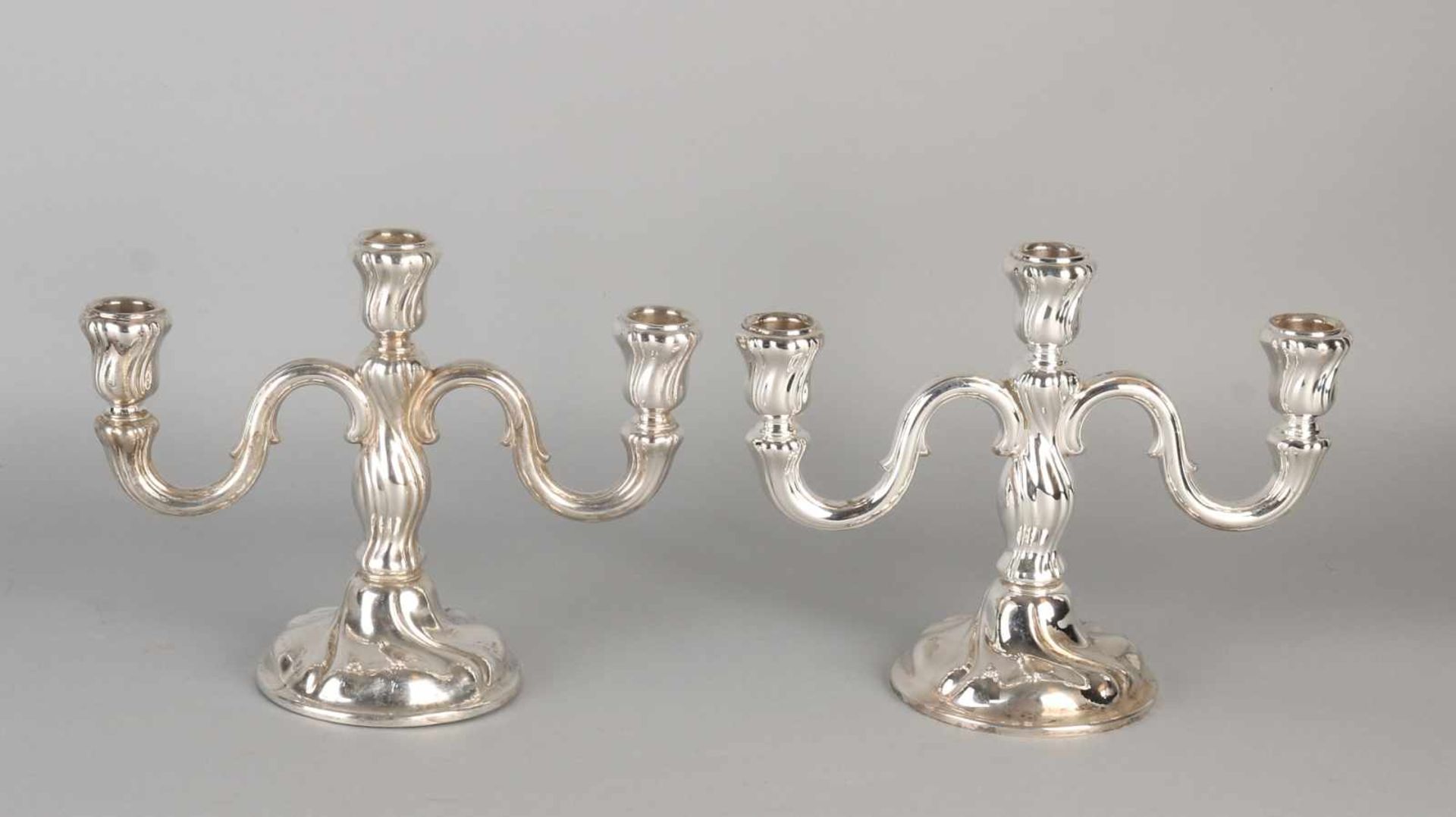 Two silver table candlesticks 835/000, 3 light on a round base with two twisted arms curled. MT .: