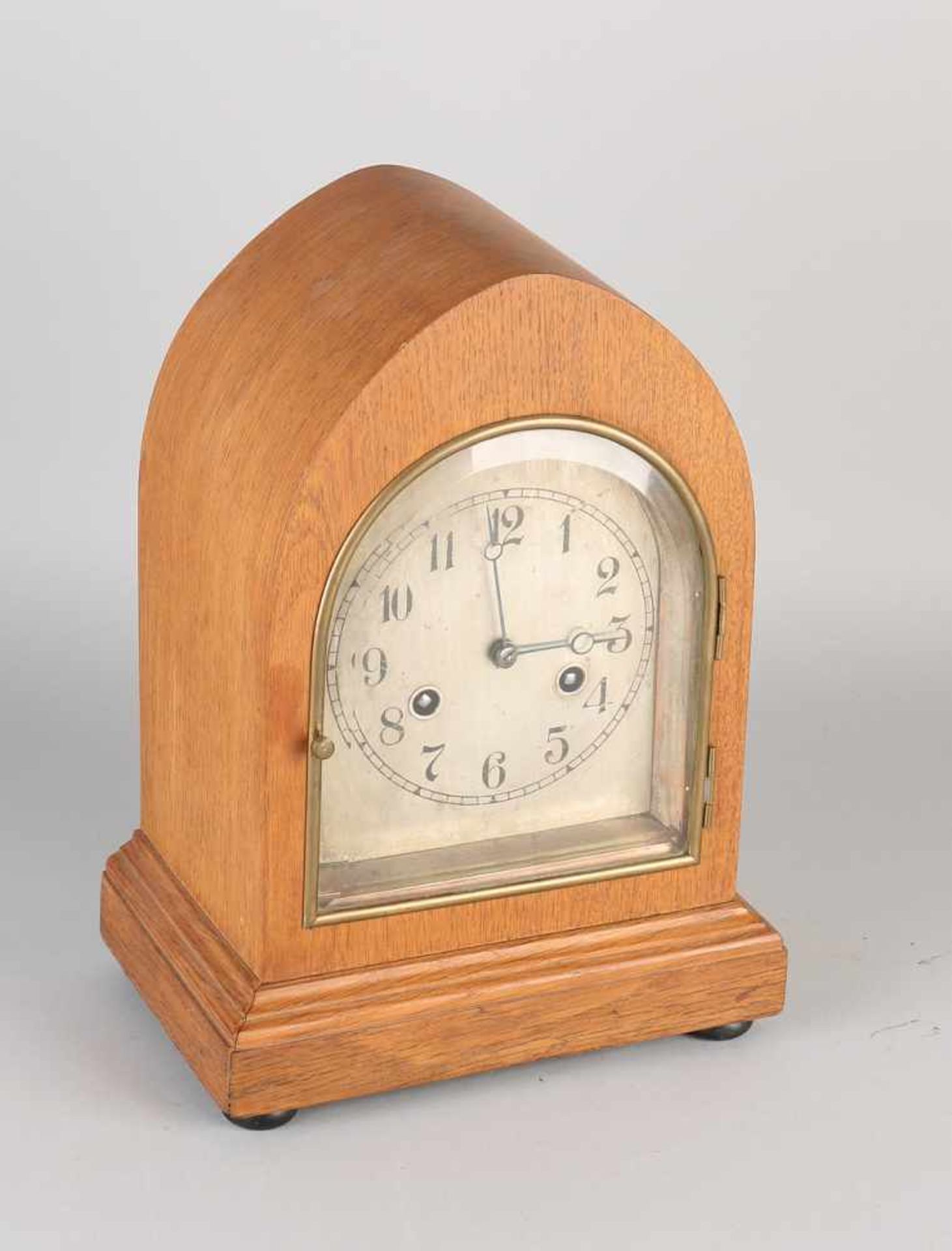 German oak table clock with plated brass dial. Circa 1920. Half-hourly stroke on gong spiral.