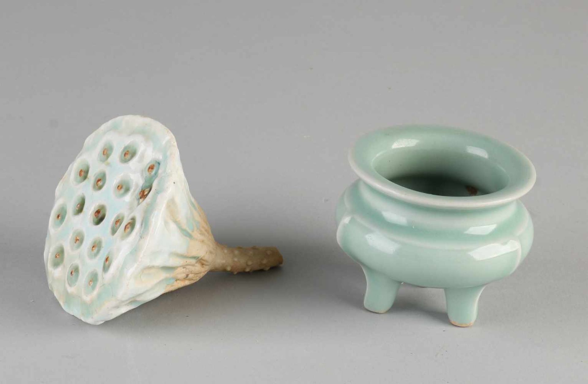 Two parts of Chinese porcelain. Comprising: Sacred lotus flower with celadon glaze. Flower Pot on