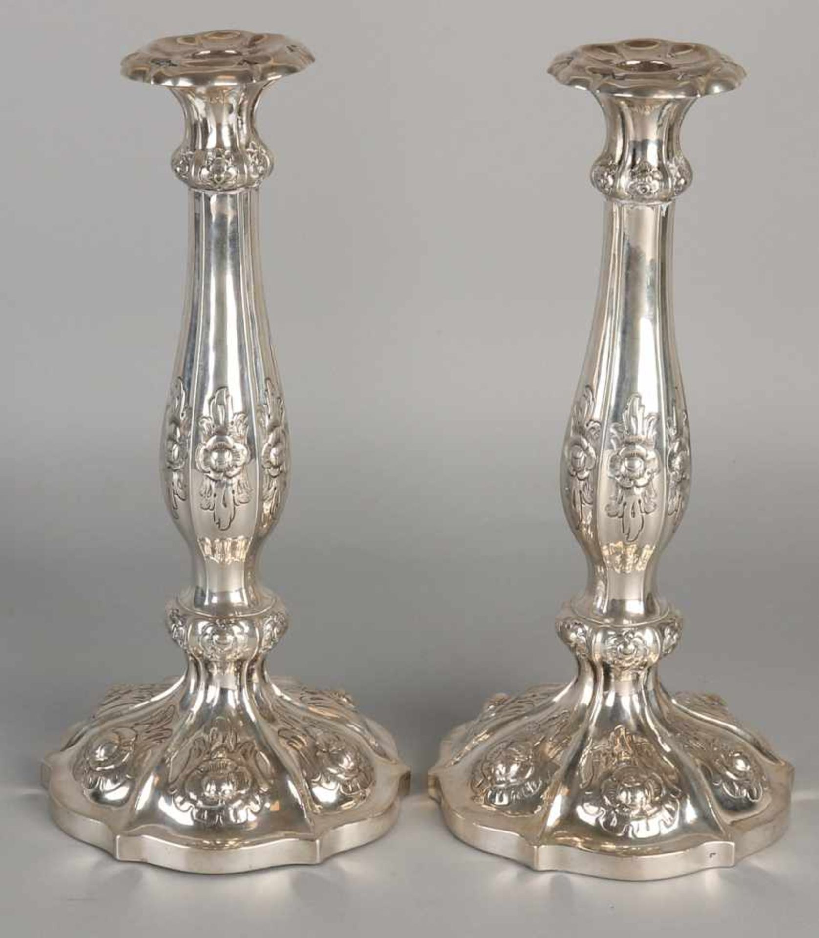 Set silver candlesticks 812/000, on molded round base decorated with floral decor. ø15x29cm. Vienna,