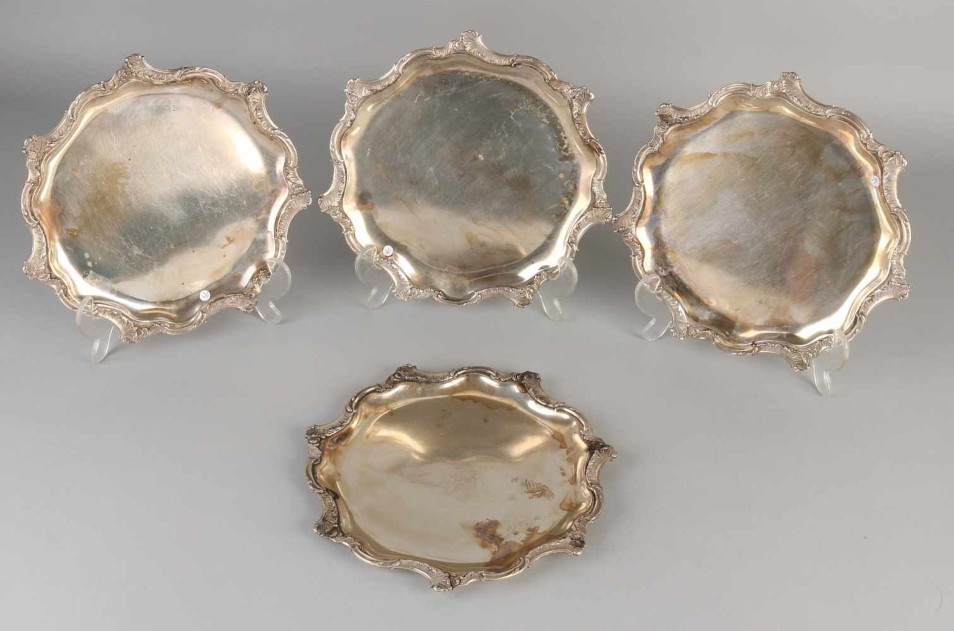 Four silver plates coasters, 800/000, round molded coasters with a border of scrolls with leaf