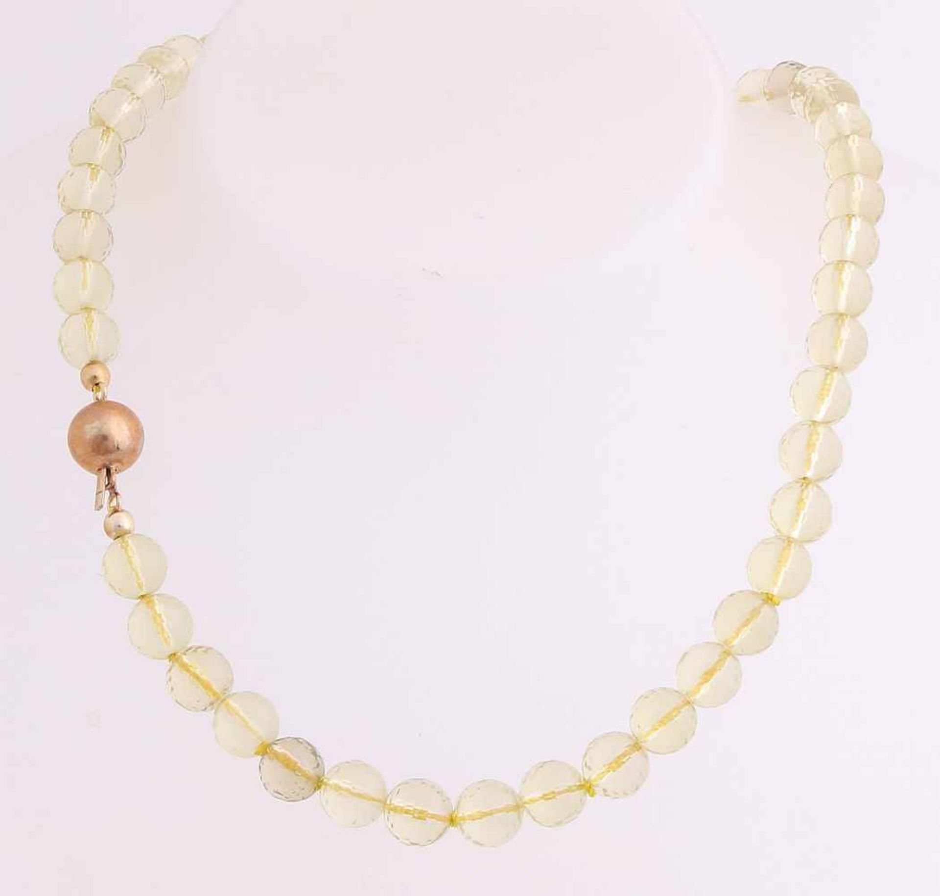 Collier of faceted citrienkralen, ø 7.5 mm, attached to a yellow-golden ball-clasp, ø 10 mm.