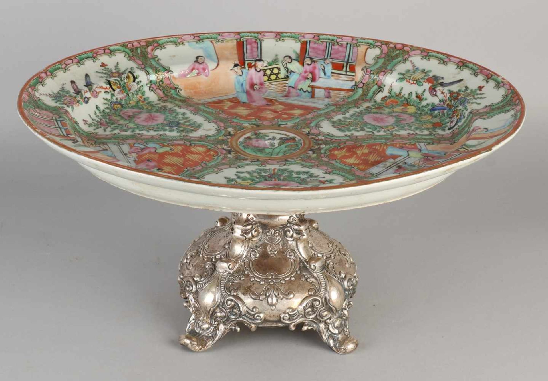 Cantonese dish placed on heavy silver base with four curved legs decorated with lions' heads,