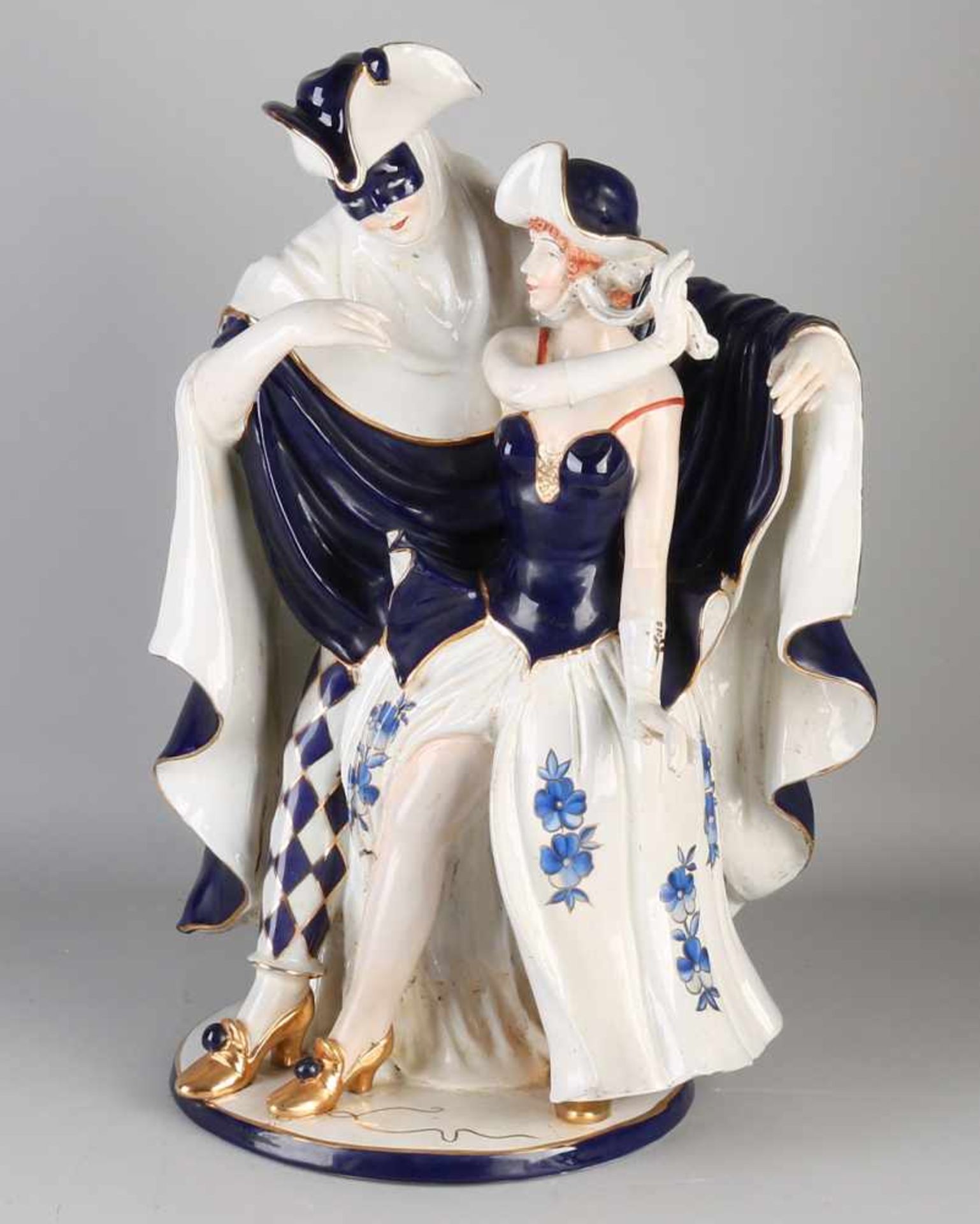 Very large French / Italian porcelain figure. 20th century. Costumed couple. Blue-white + gold