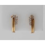 Gelbgold-Ohrclips, 585/000. Schmale, längliche Ohrclips mit 8 Diamanten im Brillantschliff,