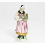 PORCELAIN FIGURE OF A FARMWOMAN WITH HEN.