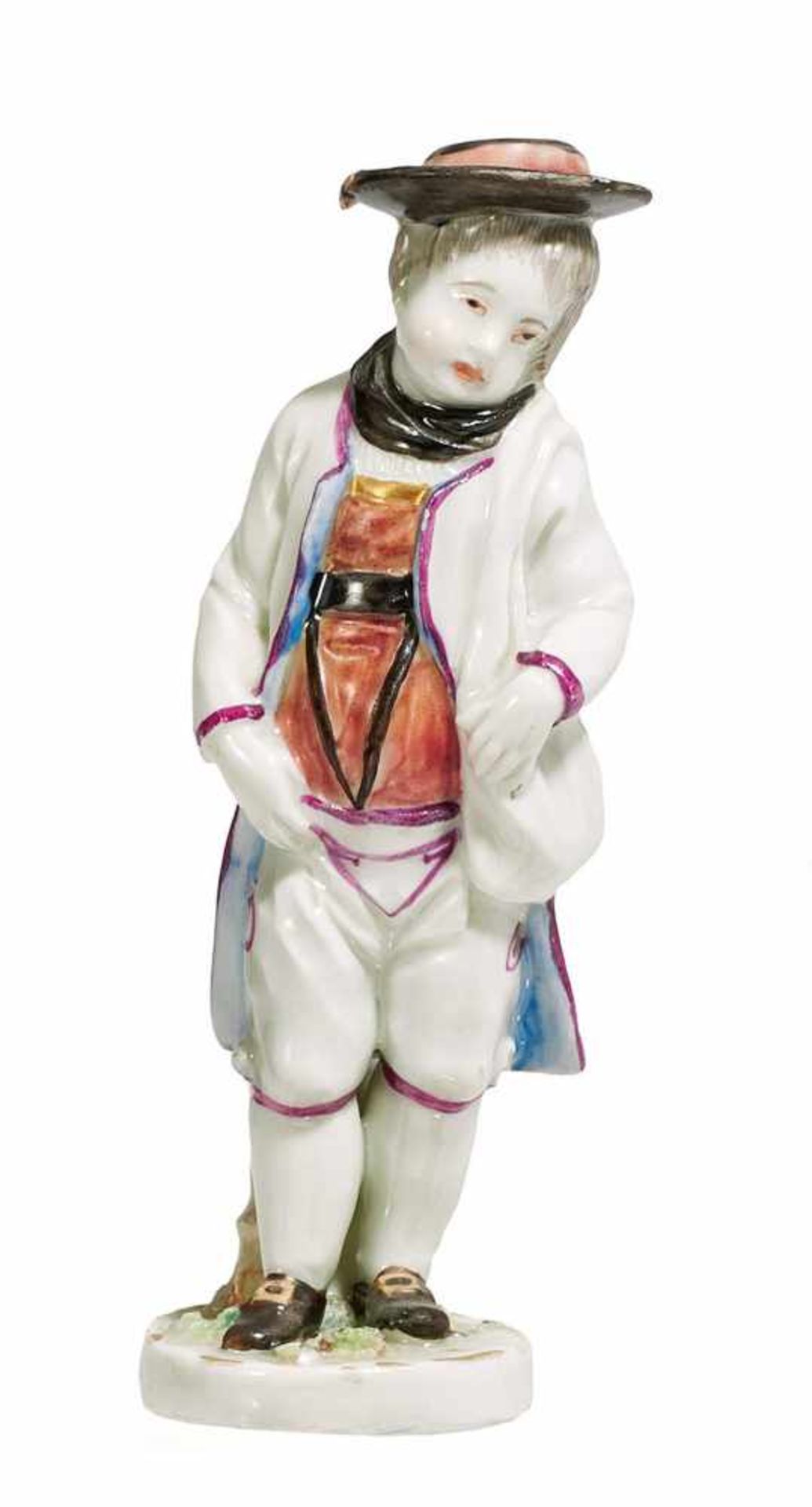 SMALL PORCELAIN FIGURE OF A BOY IN TRADITIONAL DRESS WITH SHOULDER BAG.