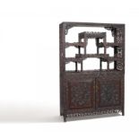 TWO-PART DISPLAY CABINET. Origin: China. Dynasty: Qing dynasty. Date: Ca. 1880. Technique: Dark hard