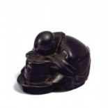 NETSUKE: ITAKURA SHIGEMUNE FALLEN ASLEEP OVER A TEA MILL. Origin: Japan. Dynasty: Edo period.