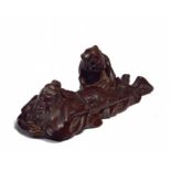 NETSUKE: SLEEPING SHÔKI WITH ONI. Origin: Japan. Date: 19th c. Technique: Dark wood, finely