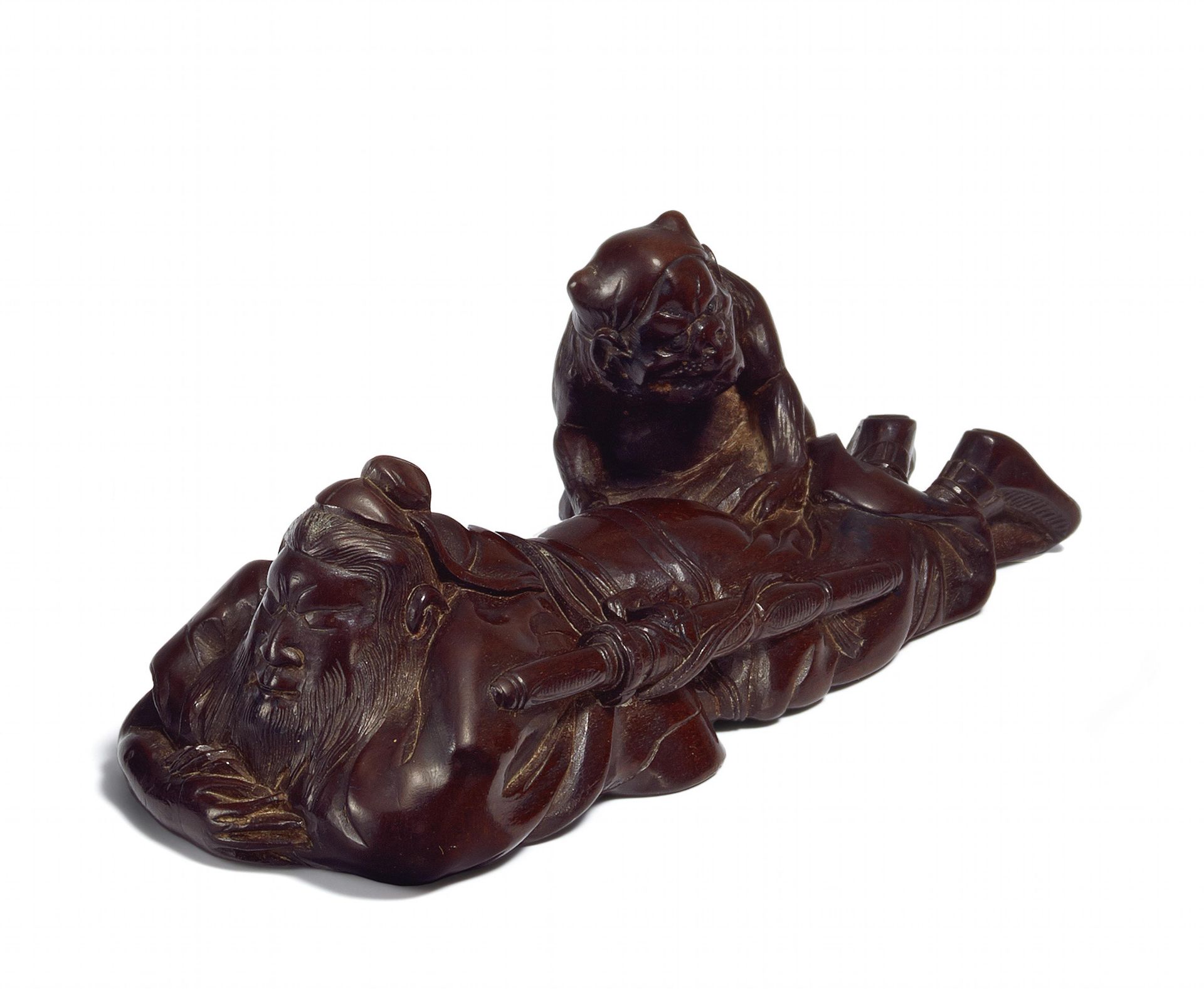 NETSUKE: SLEEPING SHÔKI WITH ONI. Origin: Japan. Date: 19th c. Technique: Dark wood, finely