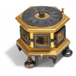 HEXAGONAL BAROQUE TABLE CLOCK MADE OF GILT BRONZE WITH RESIDUES OF SILVER PLATING AND GLASS.