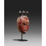 BAULE, Ivory Coast. Mask. Wood, red painted decoration. 26 x 14 x 8cm. Metal stand (24 x 11,5 x 8,