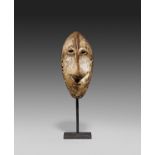 LEGA, Democratic Republic of the Congo. Mask. Wood, partial remains of kaolin. 17 x 8 x 4cm. Metal