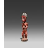 BAULE, Ivory Coast. Female figure. Wood, red painted decoration. 33 x 7 x 8,5cm. Explanations to