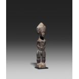 BAULE, Ivory Coast. Male figure. Wood, string necklace with small piece of metal, encrusted