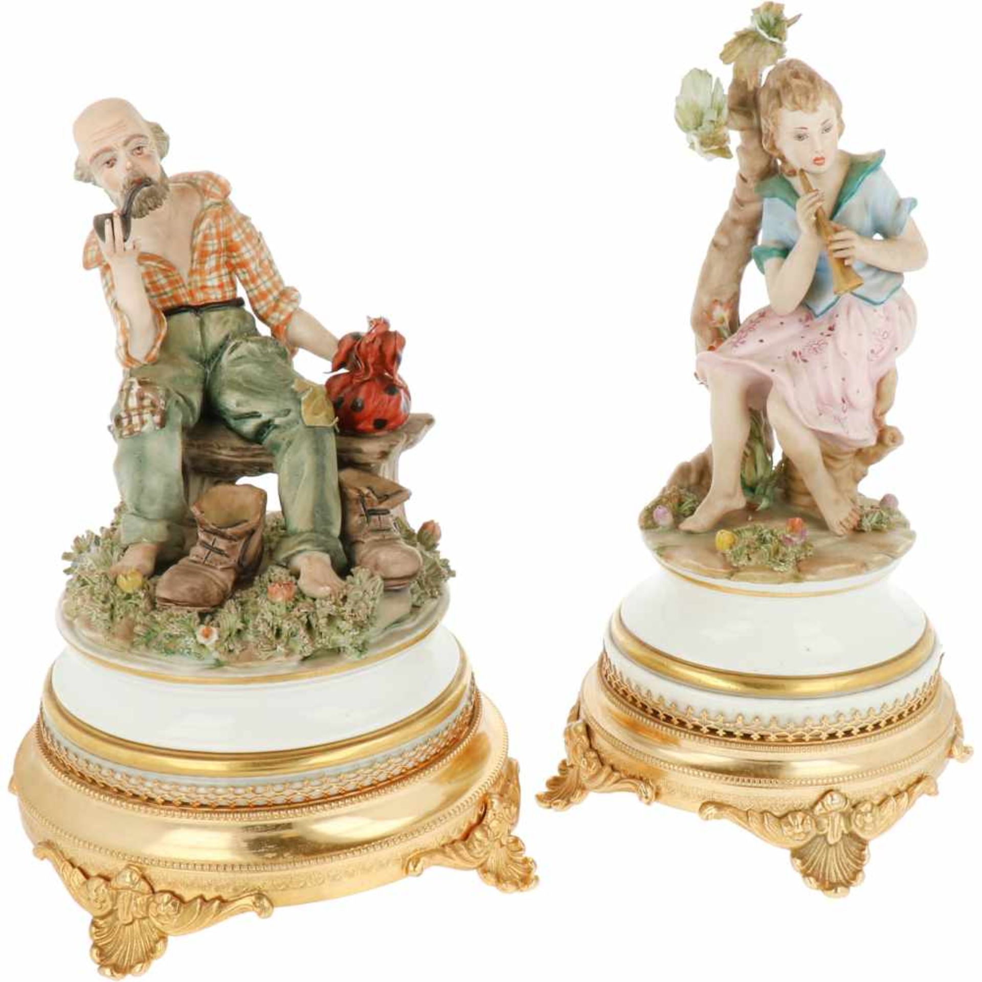 A lot with two earthenware statues depicting a smoking gentleman and music playing woman.