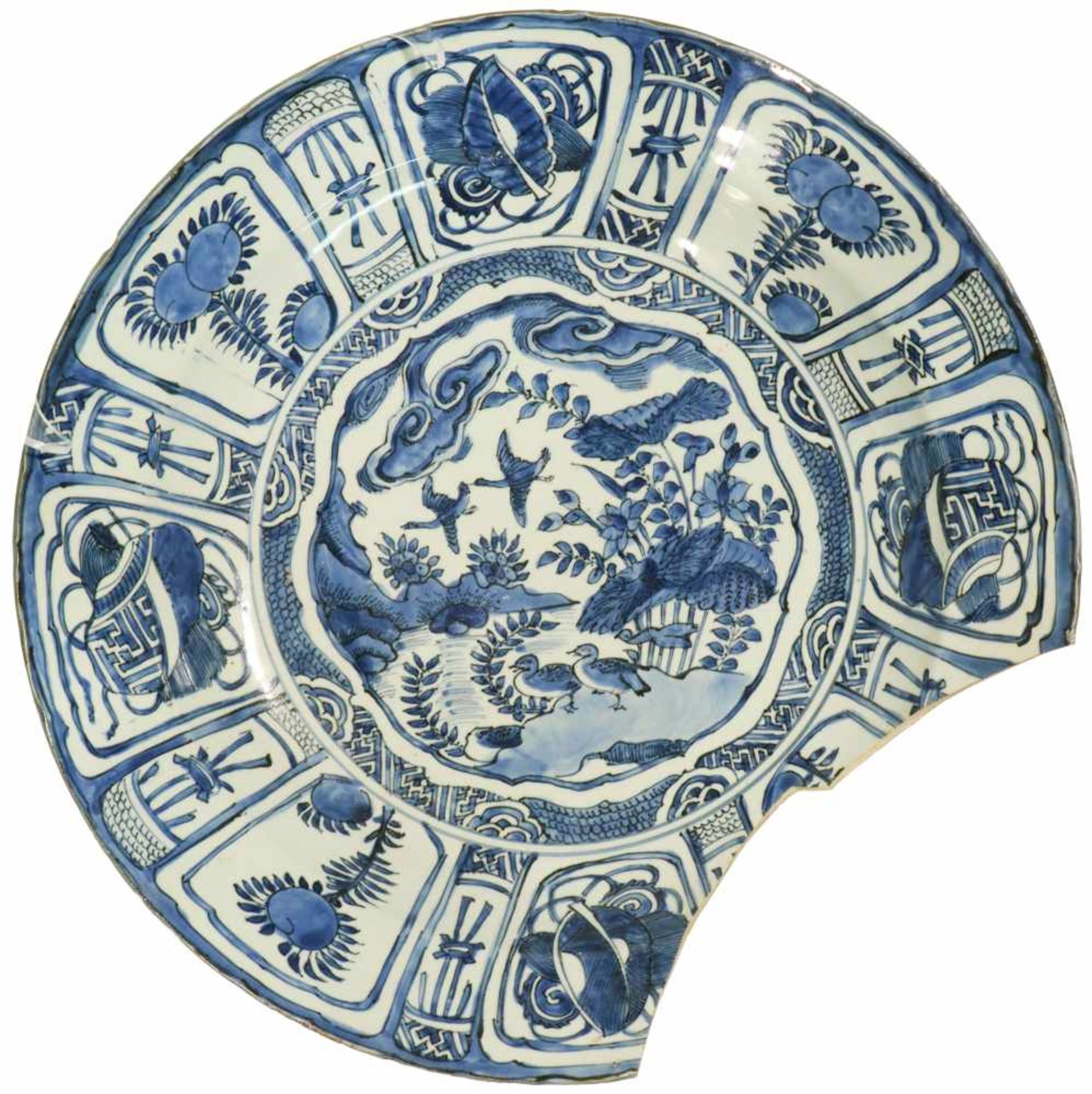 A capital porcelain 'kraak'-style dish with blue floral decor in division and landscape decor in the