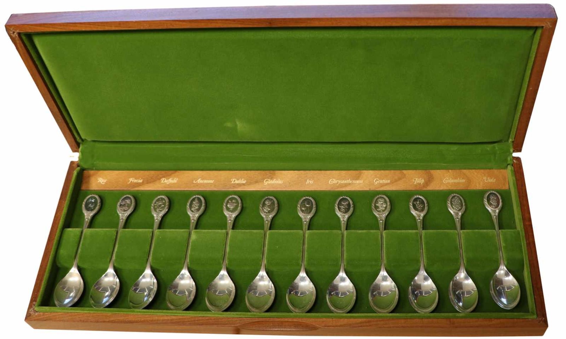 (12) Piece set of silver spoons decorated with flowers.