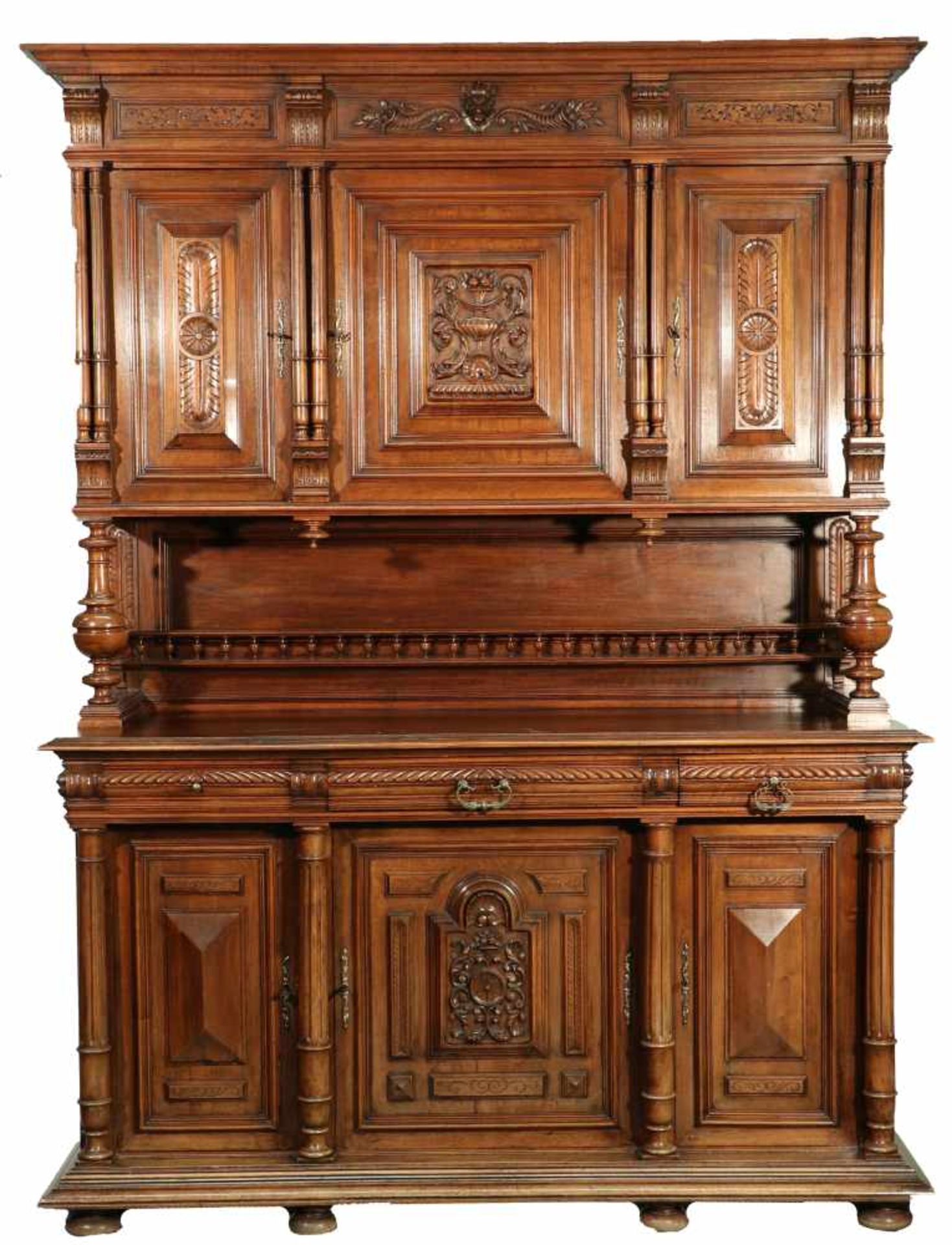 An oak cabinet with columns and brass mounts. Circa 1900.