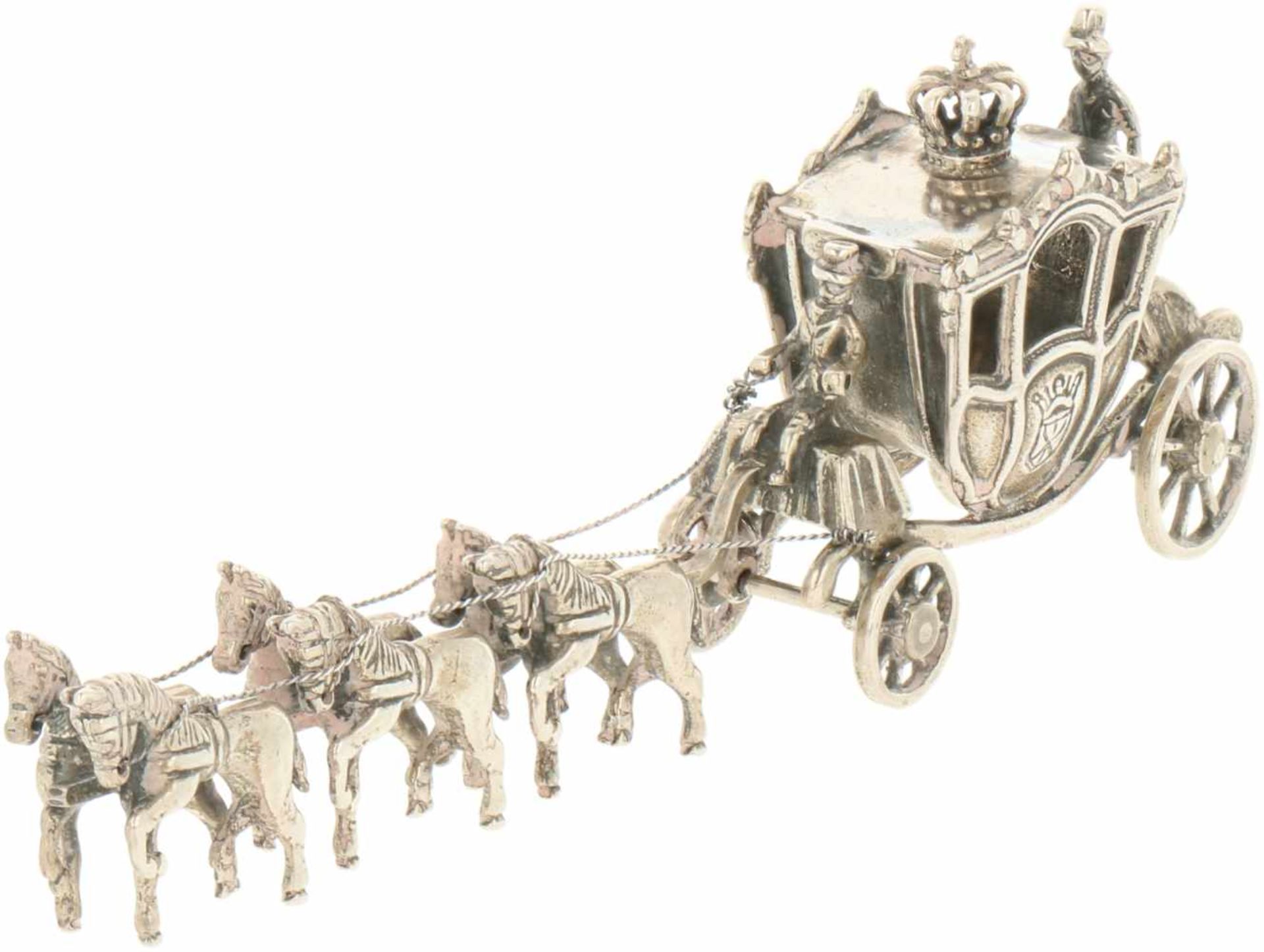 Silver carriage drawn by six horses.