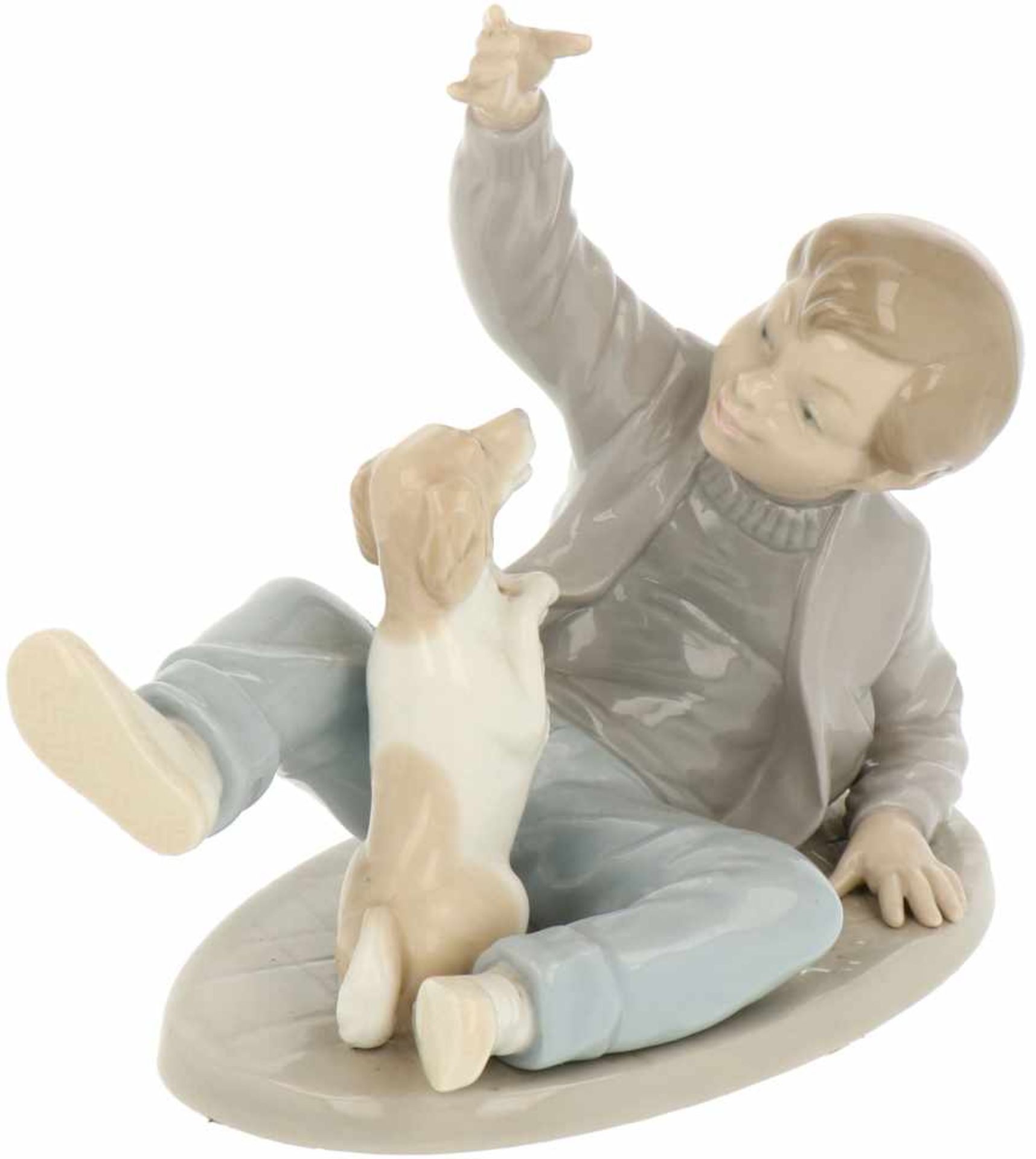 A porcelain statuette of a boy with a dog. Nao, 2nd half 20th century.