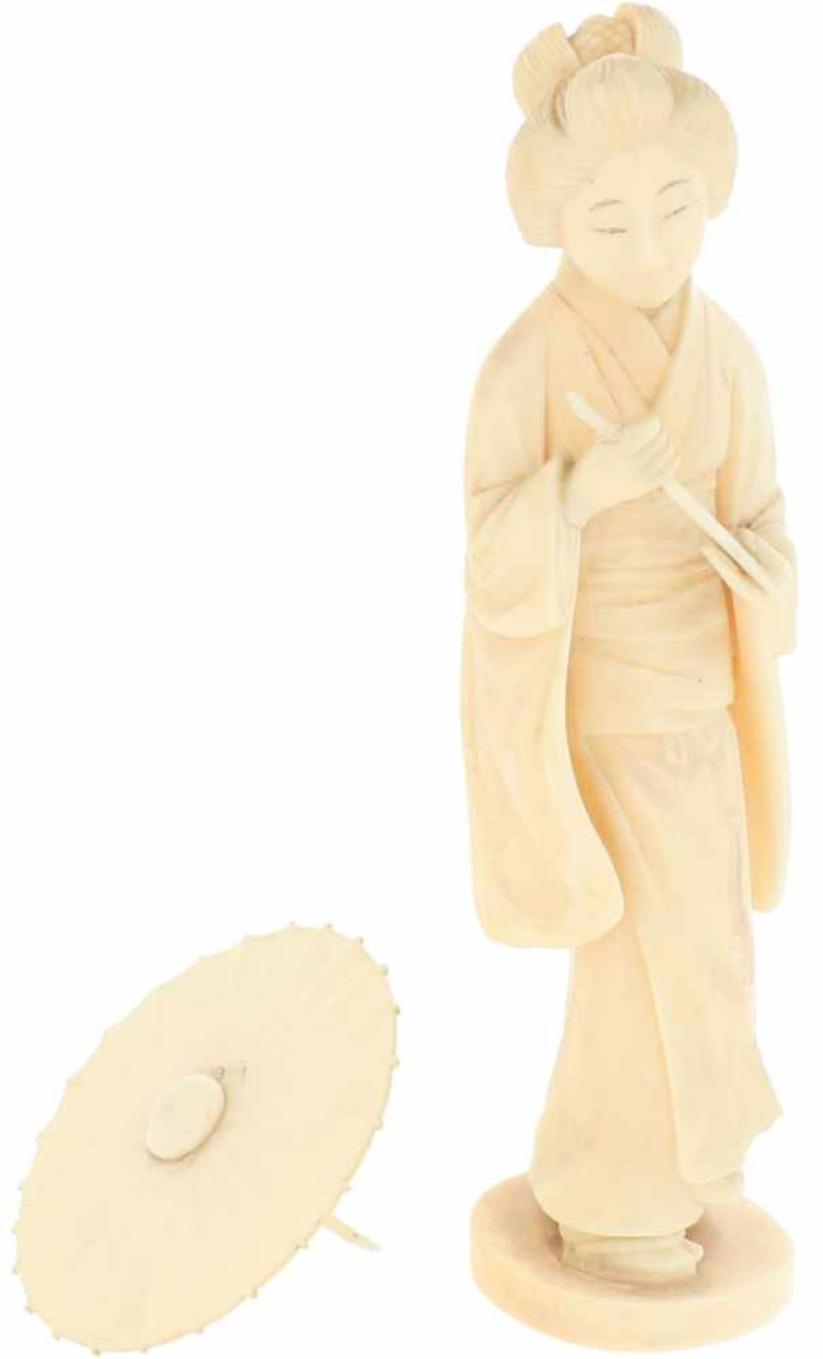 An ivory statuette in the shape of a lady with parasol. Japan, late Meiji period.