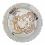 ModernA stoneware dish decorated with a love making couple, illegibly signed to the front.5 cm. h. x