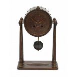 Winkelman & van der BijlA patinated copper mantle clock on columns, the cylindrical clockcase