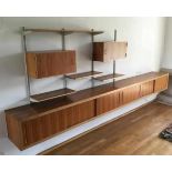 Midcentury ModernA modular wall cabinet, teak veneered, comprising an elongated cupboard compartment