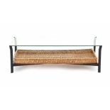 Midcentury ModernA rectangular black metal and glass coffee table with wickered cane magazine