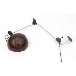SeventiesA partly brown lacquered metal adjustable wall lamp, with two black plastic hinges.max. 115