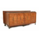 TraditionalismeAn oak sideboard with marble top, on gilt feet, the doors with brass lining and