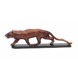 Art DecoA lacquered wooden figure of a walking lioness, on ebonised wooden base, unsigned.14 x 52
